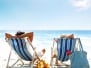Couple On A Deck Chair Relaxing On The Beach