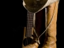 Spotlight on country music symbols cowboy boots acoustic guitar and hat