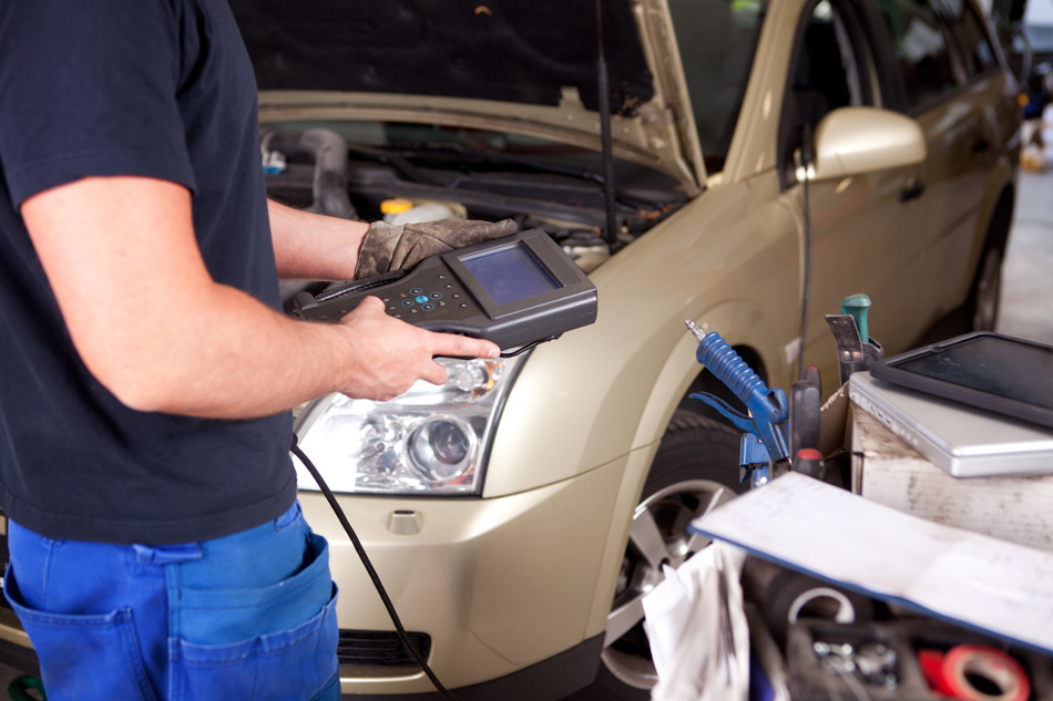 Detail Of A Mechanic With An Diagnostics Tool