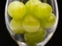 White Grapes In Wine Glass On Black Background