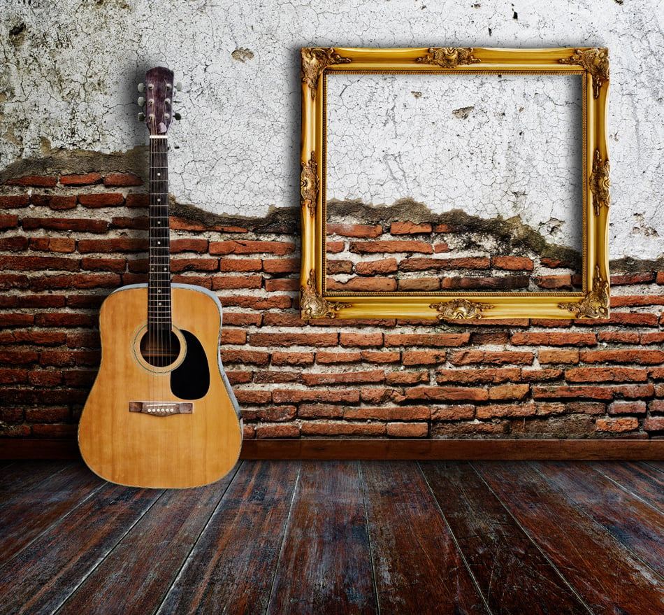Guitar and picture frame in grunge room
