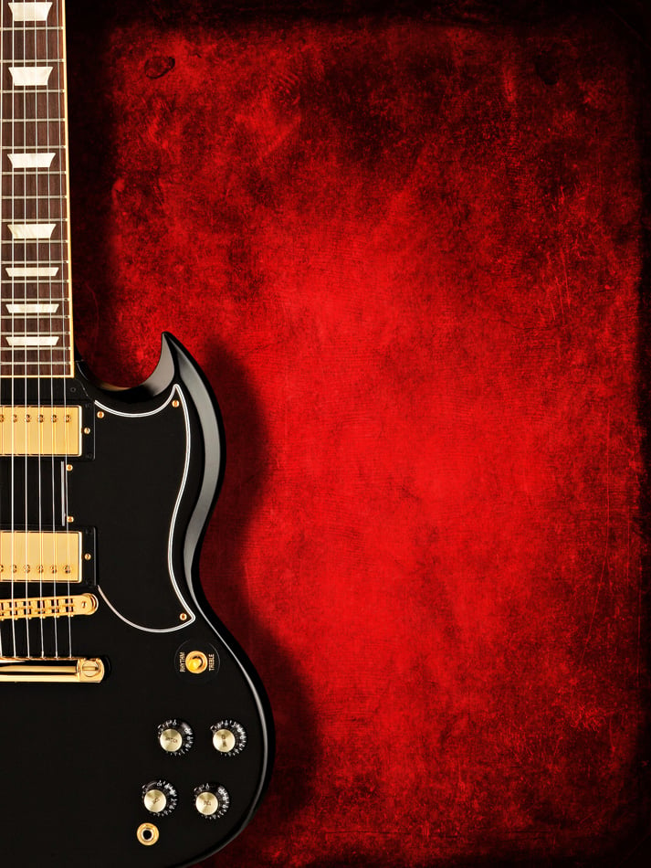 Electric Black Guitar On Dark Red Background