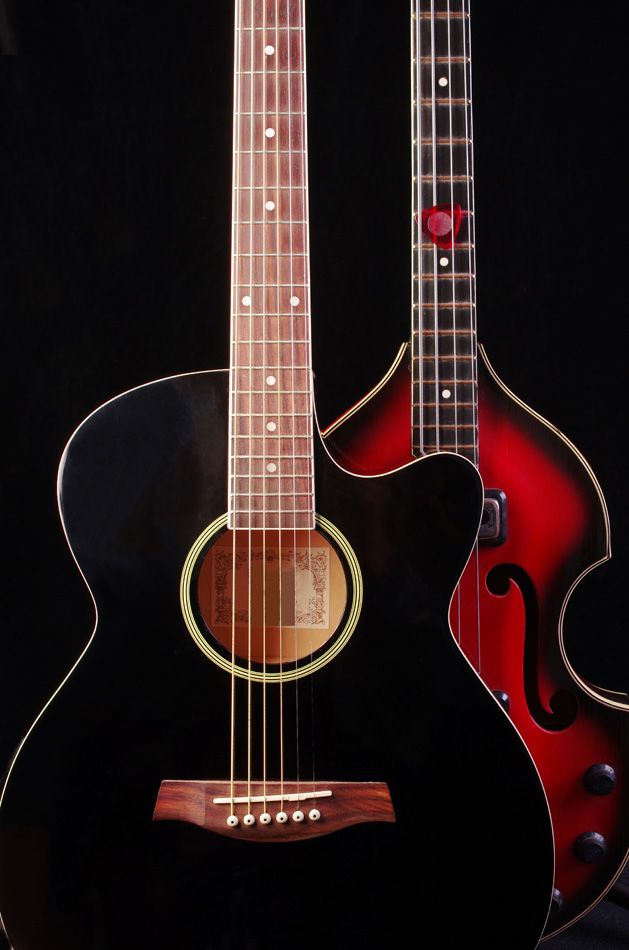 Acoustic and bass guitars on black