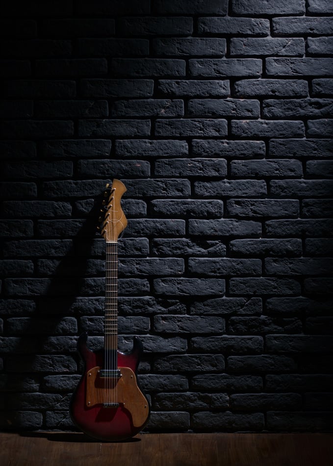 Electric Guitar Leaning On Brick Wall