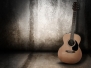 Wooden acoustic guitar on grunge textured wall