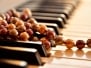 Pearl necklace on piano keyboard