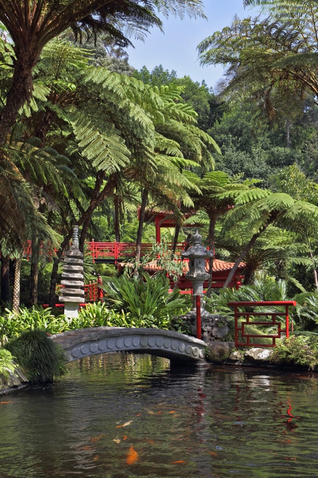 Red Chinese Style Pavilions And Bridge Over A Pond