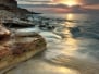 Beautiful rocky sea beach at the sunset in the summer