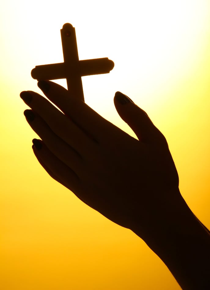 Female Hands With Crucifix - On Yellow Background