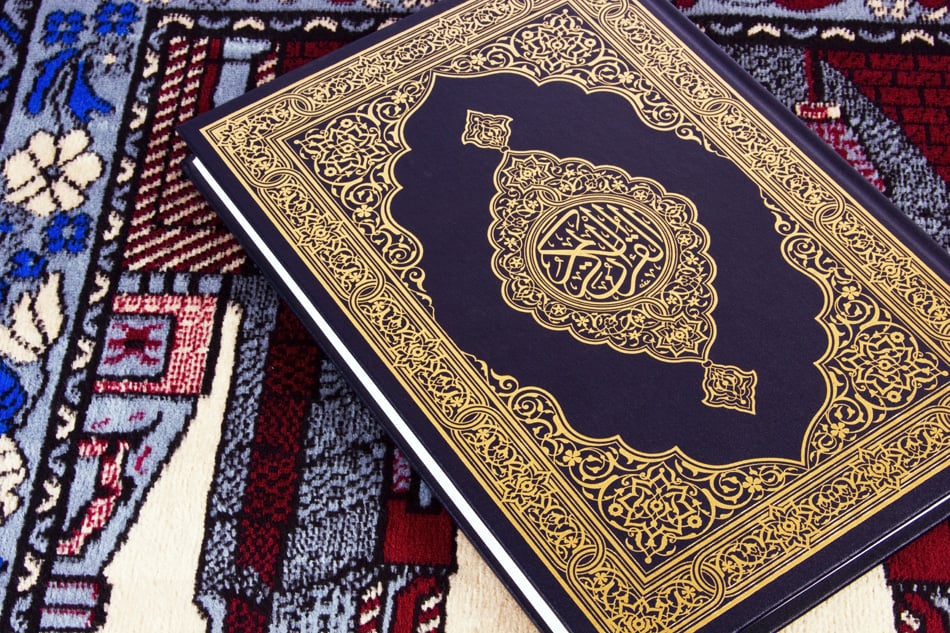 Qur'An Over Muslim Prayer Carpet