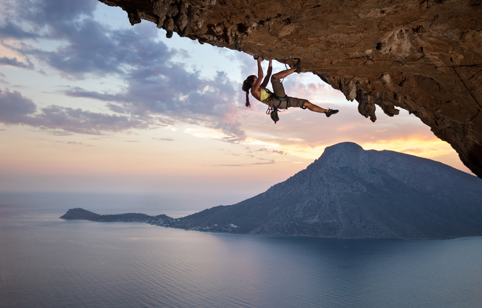 Young female rock climber at sunset Kalymnos Island Greece