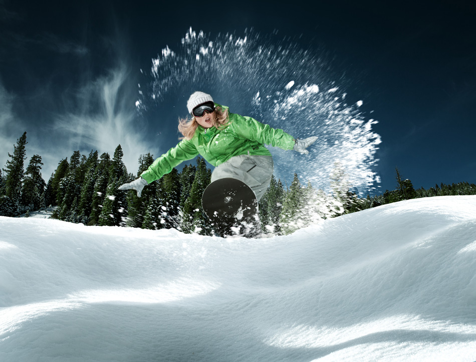 view of a young girl snowboarding in winter environment