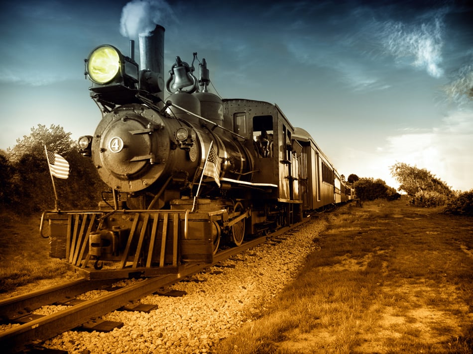 Vintage Steam engine locomotive train moving down railroad track towards 
camera