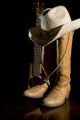 Spotlight on country music symbols cowboy boots acoustic guitar and hat - ID # 131286080