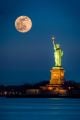 Statue of Liberty and a rising supermoon in New York City - ID # 278305580