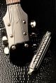 close-up of electric guitar headstock and harmonica - ID # 40481566