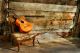 spanish guitar on a old chair with wooden background horizontal - ID # 97111277