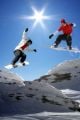 Snowboarders jumping against blue sky - ID # 64067500