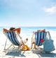 Couple On A Deck Chair Relaxing On The Beach - ID # 12999098