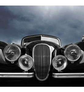 Vintage classic car front view with dark clouds - ID # 217901434